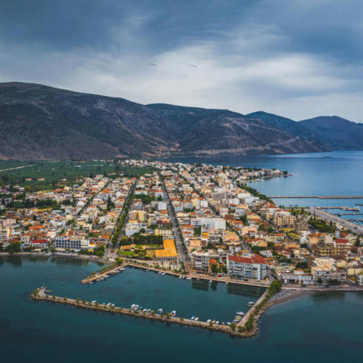 Aerial panoramic view of the coastal town of Itea with the Corinthian Gulf and surrounding mountains