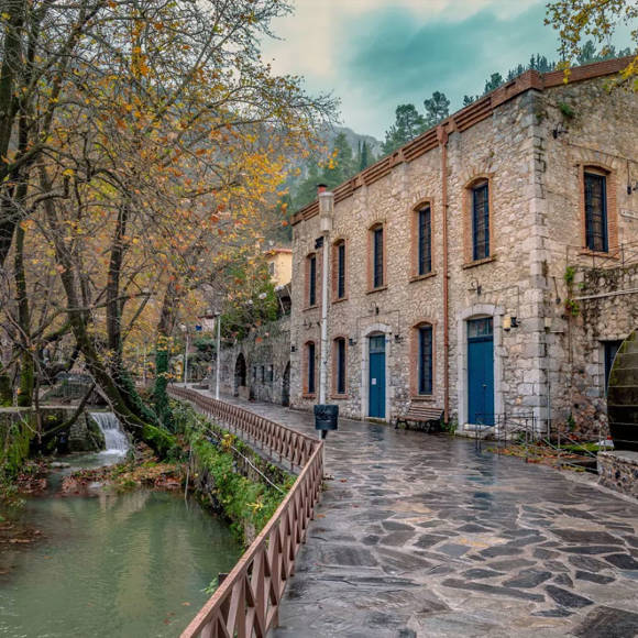 Traditional stone houses and narrow roverside streets by the Erkyna stream in Livadia