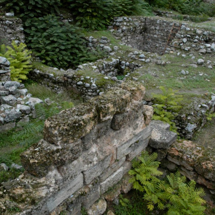 Ancient ruins of the archeological site in Thebes, showing stone foundations 