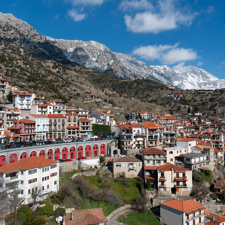 Aerial view of Arachova village center with traditional stone buildings and mountain backdrop