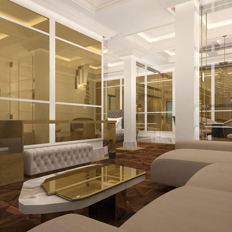 Elegant living room with beige sofas, marble coffee table, and golden wall panels reflecting warm light