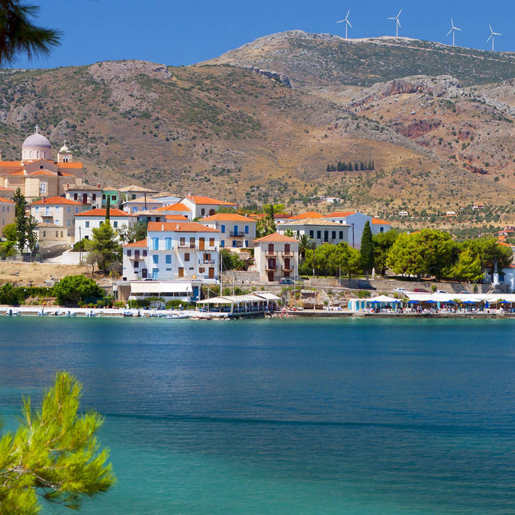 Coastal view of Galaxidi with colorful seaside houses, church domes, and calm blue waters