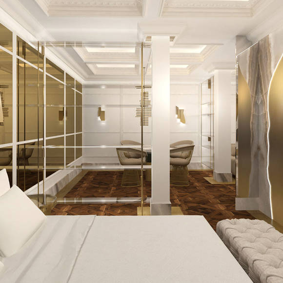 Refined bedroom with gold wall panels, mirrored surfaces, and elegant seating area in Royal Golden Suite